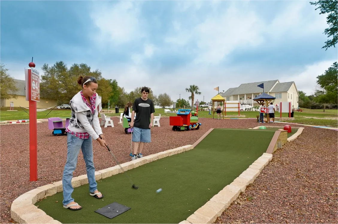 mini golf in the backyard at Sweet Escape Mansion VRBO airbnb luxury rental home near Orlando and Disney