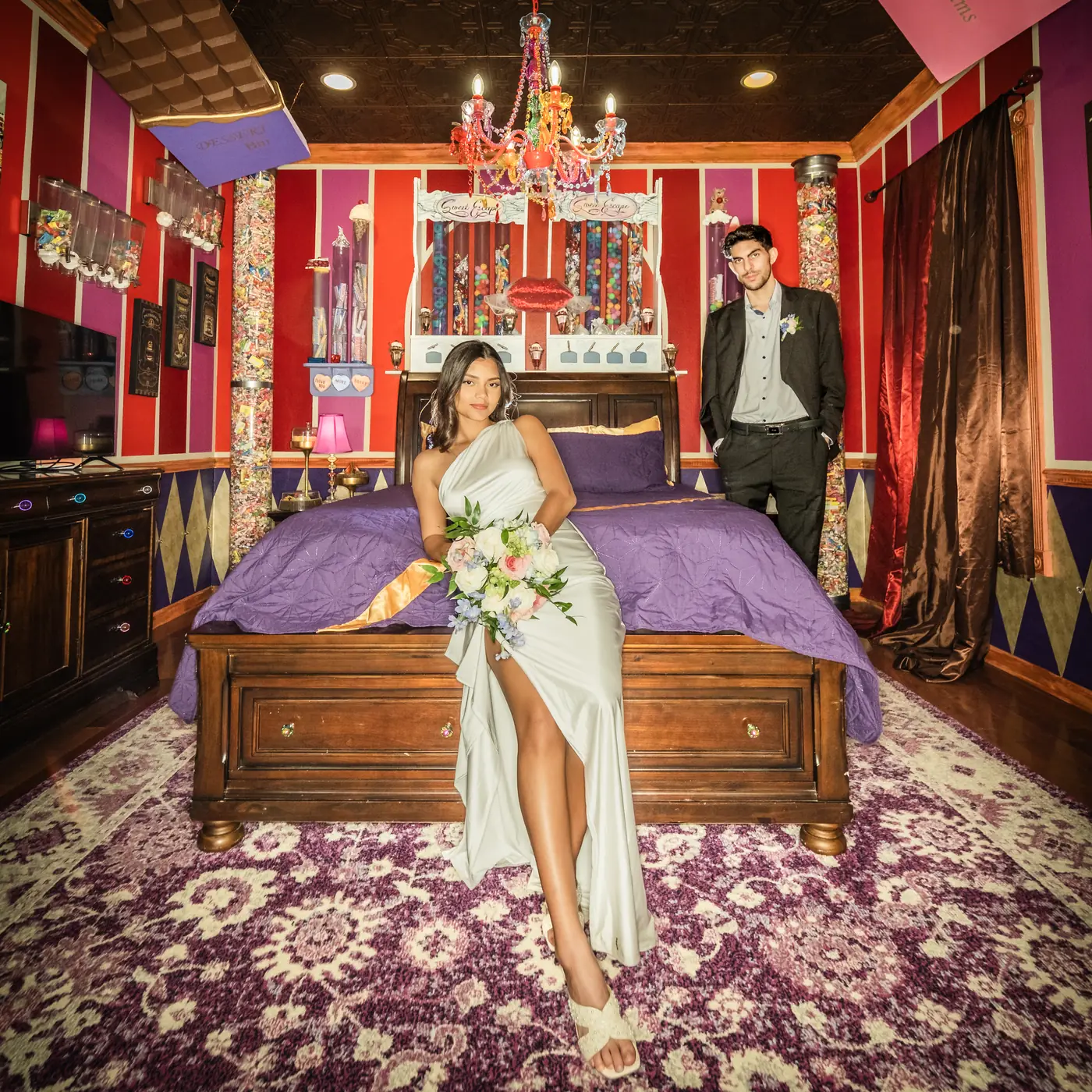 Bride and groom portrait inside the candy themed bedroom at The Sweet Escape House
